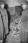 Congressman John M. Vorys(right) viewing a room full of corpses while on an inspection of the Dachau concentration camp.