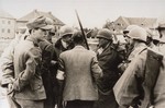 General Henning Linden, assistant commanding general, 42nd Rainbow Infantry Division, confers with various officials during the liberation and surrender of the Dachau concentration camp.