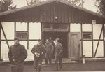 American soldiers inspect the site of the first crematorium in Dachau.