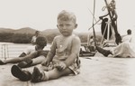 Peter Reis, a Jewish refugee child, sits on the deck of the SS Virgilio near the Panama Canal.