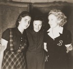 Three young women pose in the Cernauti ghetto.

Pictured from left to right are Erika Neuman, Celine Osterow and Beatrice Neuman.