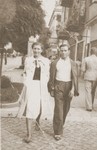 A young Jewish couple walks along a street in Zwolen, Poland.