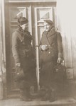 Two Jewish sisters pose outside a door in Lancut, Poland.