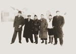 Group portrait of Jewish DPs standing in the snow in the Bergen-Belsen displaced persons camp.