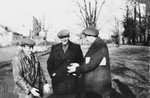 Three Jewish friends converse outside in Kielce.

Among those pictured is Zygmunt Godzinski (right).