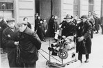 A group of Jewish men haul material through what probably is the Lodz ghetto.