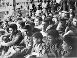 Jewish youth who were members of the Buchenwald children's transport sit outside at a meeting in the Ecouis children's home.