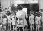 Simone Weil plays the piano for the children at the Le Petit Monde home near Paris.