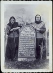Mrs. Polaczek and her daughter Mariyasl Yurkanski stand by the grave of their husband and father, Meir Yaakov Polaczek.