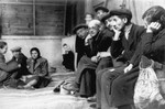 Jews who have been rounded-up for deportation in the Lodz ghetto are held at an assembly point on Krawiecka Street until trains are available to transport them out of the ghetto.