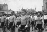 The Maccabi boxing team stands in formation in a square in Krakow, wearing their boxing gloves.