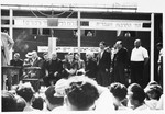 Jewish DP leaders and invited guests are assembled on a podium at an outdoor public meeting [probably in the Schlachtensee displaced persons camp].