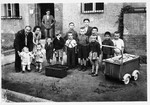 Jewish DP children pose outside a building in the Mariendorf displaced persons camp.