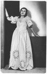 A young Jewish woman from Salonika poses in a ball gown.