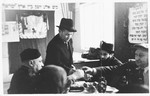 UNRRA camp director Harold Fishbein shares a toast with a group of religious Jews at a circumcision ceremony in the Schlachtensee displaced persons camp.