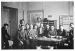 [Group portrait of members of the administrative staff in an office in the Schlachtensee displaced persons camp.]