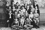 Group portrait of OSE staff and Jewish DP youth who numbered among the Buchenwald children, at an OSE (Oeuvre de Secours aux Enfants) children's home in France [either in Ambloy or Taverny].