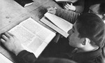 Jewish DP youth who numbered among the Buchenwald children, study religious texts at an OSE (Oeuvre de Secours aux Enfants) children's home in France [either in Ambloy or Taverny].