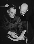 Defendants Wilhelm Keitel and Fritz Sauckel read over a document at the International Military Tribunal trial of war criminals at Nuremberg.