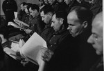The defendants receive the indictment against them at the trial of 61 former camp personnel and prisoners from Mauthausen.