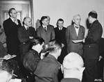 Defense attorney Dr. Otto Stahmer, the counsel for Hermann Goering, is introduced to a roomful of news correspondents before the beginning of the International Military Tribunal trial of war criminals at Nuremberg.