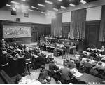 American Major Frank B. Wallis (standing), a member of the trial counsel and trial preparation legal staff, presents the prosecution's case to the International Military Tribunal at Nuremberg.