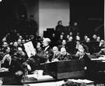 Executive trial counsel Colonel Robert G. Storey presents as evidence a document detailing Nazi intentions to launch an aggressive war, at the International Military Tribunal trial of war criminals at Nuremberg.