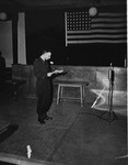 U.S. prosecutor William Denson reads over the indictment at the trial of 61 former camp personnel and prisoners from Mauthausen.