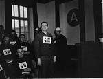 Former SS-Unterscharfuehrer Josef Niedermayer, a defendant at the trial of 61 former camp personnel and prisoners from Mauthausen, stands in his place in the defendants' dock.