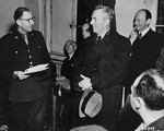 Dr. Hans Marx, the lawyer representing Julius Streicher, is introduced to a roomful of news correspondents before the beginning of the International Military Tribunal trial of war criminals at Nuremberg.