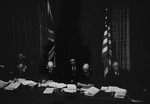 The British and American judges on the International Military Tribunal listen to testimony through their headphones at the trial of war criminals at Nuremberg.