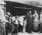 A Jewish family poses in front of their grains stall in the Drohobycz marketplace.