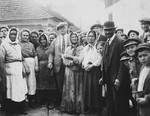 Group portrait of Jewish friends and relatives standing in the town square of Drohobycz, taken on the occasion of a visit by Harry Handel (former resident of Drohobycz) from America.