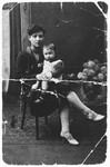 A Jewish mother holds her baby on her lap.

Pictured are Chaya Perla Frydland and her oldest daughter, Taube.