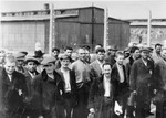 Jews from Subcarpathian Rus who have been selected for forced labor at Auschwitz-Birkenau are assembled in front of a barracks.