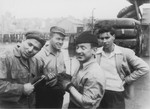Four crew members of an illegal immigrant ship to Palestine [possibly the Haganah or the Josiah Wedgewood] pose at Brewer's Dry Dock, Staten Island on the day they set sail for Europe to pick up Jewish DPs.