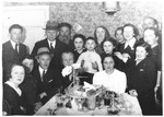 The Gertner family gathers around a table to celebrate the wedding of Josef and Peppa Gertner.