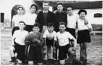 Group portrait of the members of a boy's soccer team wearing shirts with a Star of David.