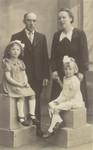 Studio portrait of a Belgian family with the Jewish child they are hiding.