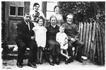 The Kejles family poses outside its home in Grodzisk.