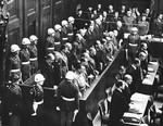 View of the defendants standing in the dock during the International Military Tribunal in Nuremberg.