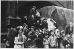 Jewish orphans, wearing costumes,  from a Tiefenbrunner children's home gather in front of a covered truck in Amseremme, Belgium.