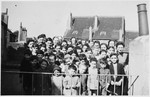 Group portrait of Jewish refugee children at the Orphelinat Israelite de Bruxelles children's home posing on the roof of the home at rue des Patriotes.