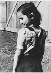 Portrait of a young girl in the Loborgrod concentration camp wearing a Jewish badge.
