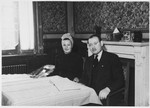 Jonas and Ruth Tiefenbrunner sit at their dining room table [probably at the Mariaburg DP children's home near Antwerp].