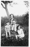 The Hubert family poses in the fruit orchard of their home.