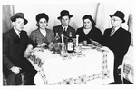 Jewish DPs from Rokitno, Poland are gathered around a Sabbath table at the Ebelsberg displaced persons camp near Linz, Austria.