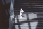 A little girl poses with a stuffed animal on the staircase in the Hall of Witness at the U.S.