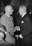 Wilhelm Frick (left) greets Franz von Papen at an unidentified reception.