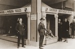 Two Jewish brothers pose outside an exhibition pavillion where their furs are on display.